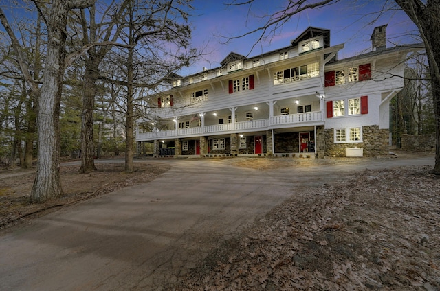 24 Summit Ave, Pocono Summit, PA 18346 - view of front of house featuring stone siding and a balcony