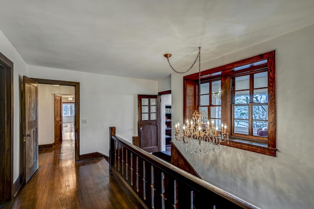 24 Summit Ave, Pocono Summit, PA 18346 - hall featuring baseboards, wood-type flooring, an upstairs landing, and a chandelier