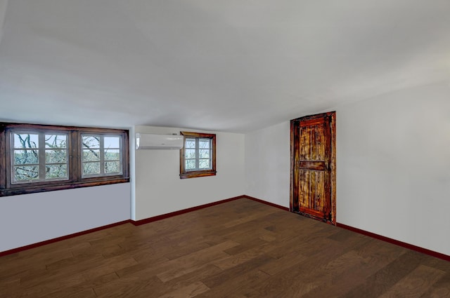 24 Summit Ave, Pocono Summit, PA 18346 - spare room with baseboards, vaulted ceiling, a wall mounted AC, and wood finished floors