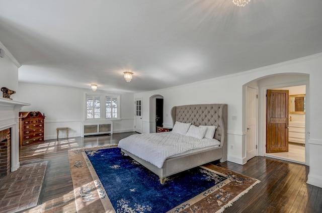 24 Summit Ave, Pocono Summit, PA 18346 - bedroom with crown molding, a fireplace, dark wood finished floors, baseboards, and arched walkways