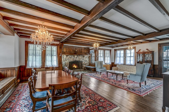 24 Summit Ave, Pocono Summit, PA 18346 - dining area with an inviting chandelier, wood-type flooring, a stone fireplace, and wainscoting