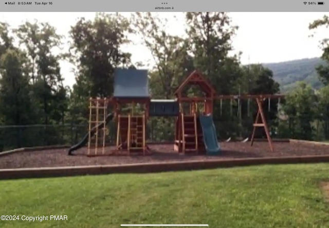 view of playground with a lawn