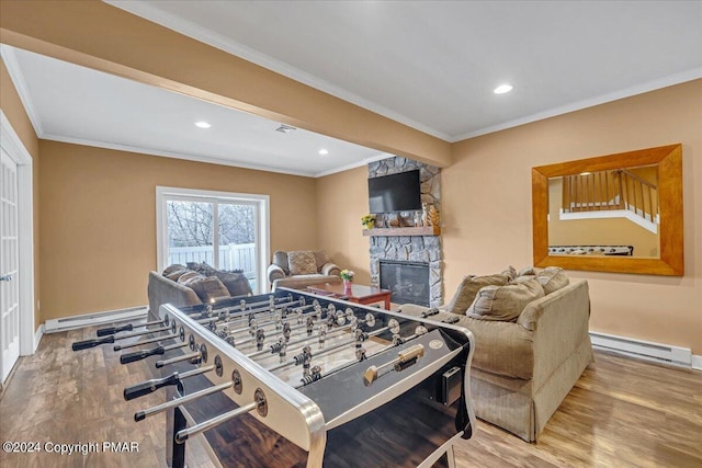 playroom featuring ornamental molding, wood finished floors, and a baseboard radiator