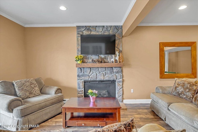 living room with a fireplace, crown molding, baseboards, and wood finished floors