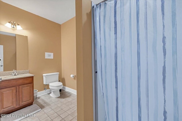 bathroom featuring baseboards, toilet, a shower with shower curtain, tile patterned floors, and vanity