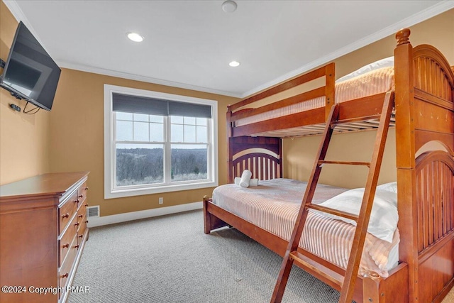 bedroom featuring light carpet, baseboards, visible vents, and ornamental molding