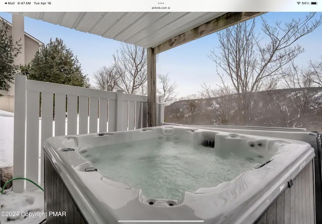 wooden deck with a hot tub