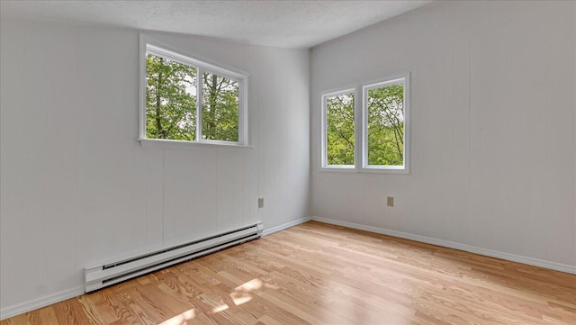 5015 Woodbridge Dr E, Bushkill, PA 18324 - spare room with a baseboard radiator, wood finished floors, and baseboards
