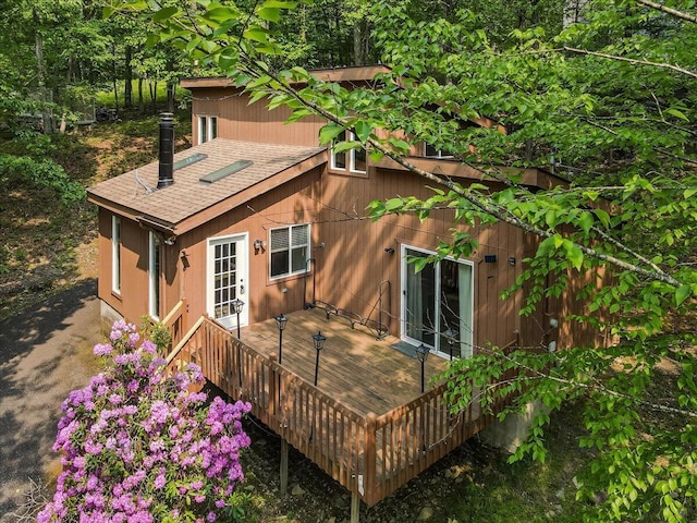 5015 Woodbridge Dr E, Bushkill, PA 18324 - back of property featuring a shingled roof and a wooden deck