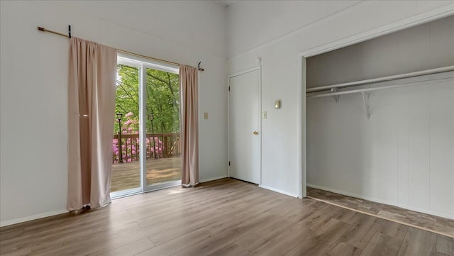 5015 Woodbridge Dr E, Bushkill, PA 18324 - unfurnished bedroom with access to exterior, wood finished floors, and a closet