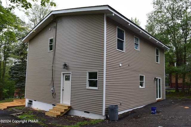 back of house with crawl space and entry steps