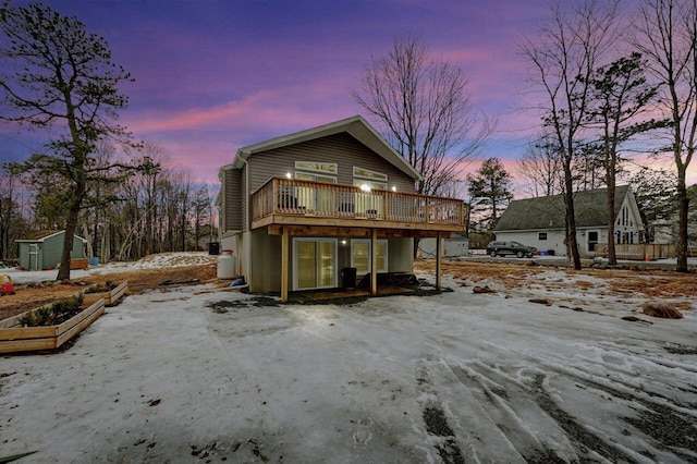 view of front of house with an outdoor structure and a deck