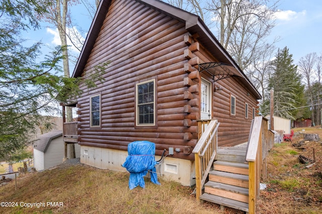 view of side of home featuring log exterior