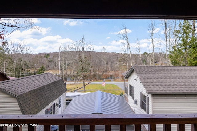 exterior space featuring a wooded view