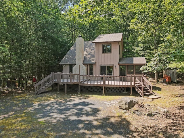 5913 NE Decker Rd NE, Bushkill, PA 18324 - rustic home with a chimney, a shingled roof, and a wooden deck