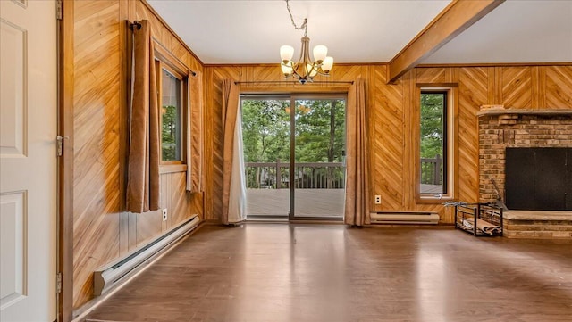 5913 NE Decker Rd NE, Bushkill, PA 18324 - doorway with a baseboard heating unit, wood walls, a chandelier, and wood finished floors