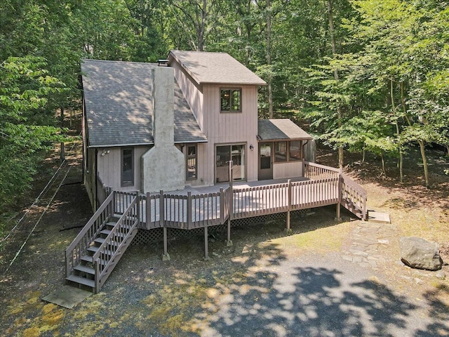 5913 NE Decker Rd NE, Bushkill, PA 18324 - view of front of house featuring a shingled roof, a sunroom, and stairway