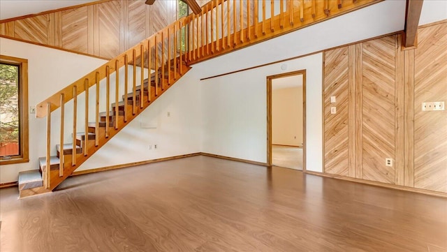 5913 NE Decker Rd NE, Bushkill, PA 18324 - unfurnished living room with wood finished floors, stairway, a towering ceiling, and wood walls