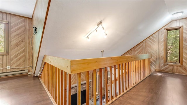 5913 NE Decker Rd NE, Bushkill, PA 18324 - hall with wooden walls, wood finished floors, vaulted ceiling, and a baseboard heating unit
