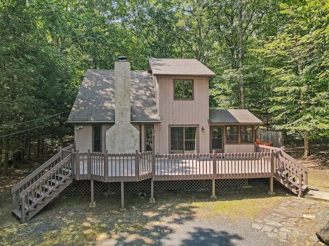 5913 NE Decker Rd NE, Bushkill, PA 18324 - rear view of house featuring stairway, a sunroom, roof with shingles, and a chimney