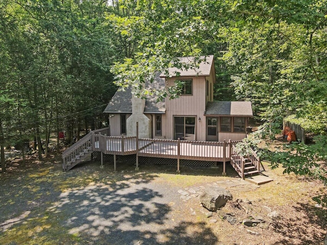 5913 NE Decker Rd NE, Bushkill, PA 18324 - chalet / cabin featuring a shingled roof, a deck, and stairs