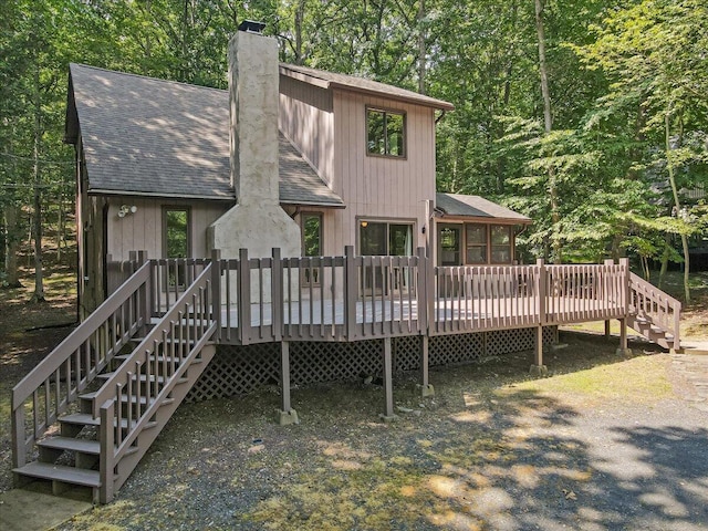 5913 NE Decker Rd NE, Bushkill, PA 18324 - back of house with roof with shingles, a chimney, stairway, and a deck