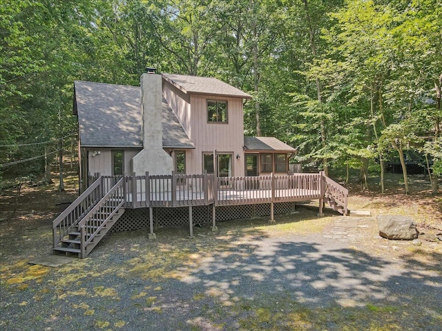 5913 NE Decker Rd NE, Bushkill, PA 18324 - view of front of home featuring a shingled roof, a chimney, stairs, and a deck