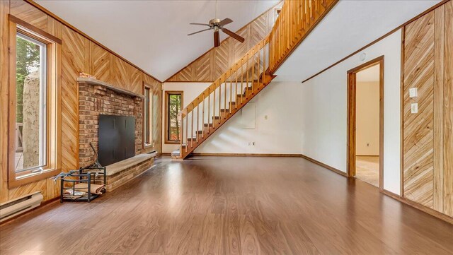 5913 NE Decker Rd NE, Bushkill, PA 18324 - unfurnished living room featuring wood finished floors, stairs, ceiling fan, vaulted ceiling, and wood walls
