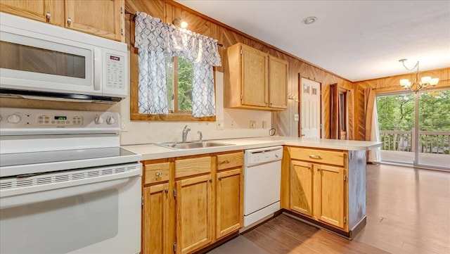 5913 NE Decker Rd NE, Bushkill, PA 18324 - kitchen featuring white appliances, a peninsula, a chandelier, light countertops, and dark wood-style floors
