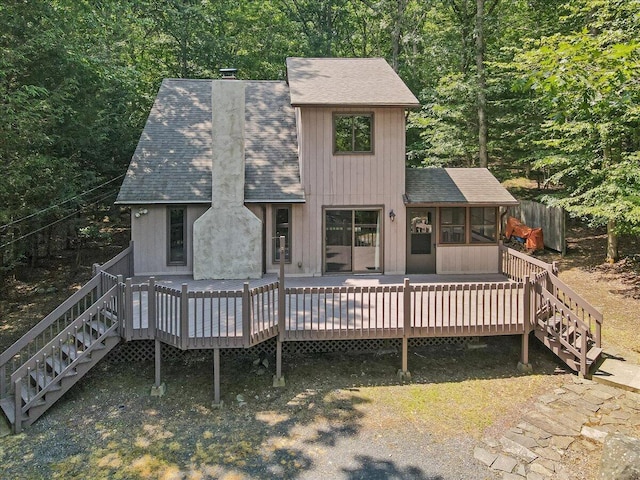 5913 NE Decker Rd NE, Bushkill, PA 18324 - rear view of house with stairs, a shingled roof, a sunroom, and a chimney