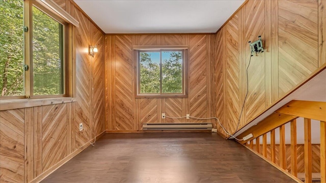 5913 NE Decker Rd NE, Bushkill, PA 18324 - empty room with a baseboard radiator, wood walls, and wood finished floors