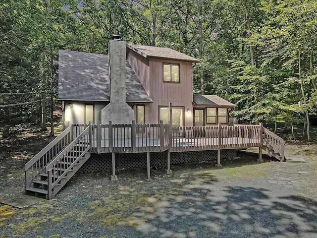 5913 NE Decker Rd NE, Bushkill, PA 18324 - rear view of house featuring roof with shingles, stairway, a chimney, and a deck