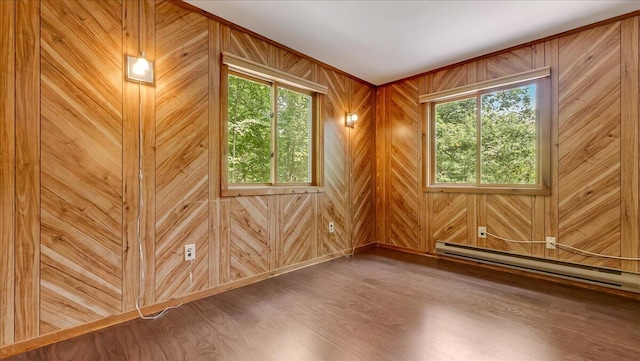 5913 NE Decker Rd NE, Bushkill, PA 18324 - spare room with wood finished floors, a baseboard heating unit, and wooden walls