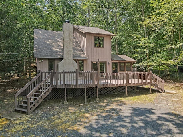 5913 NE Decker Rd NE, Bushkill, PA 18324 - rear view of house with roof with shingles, a chimney, stairway, and a deck