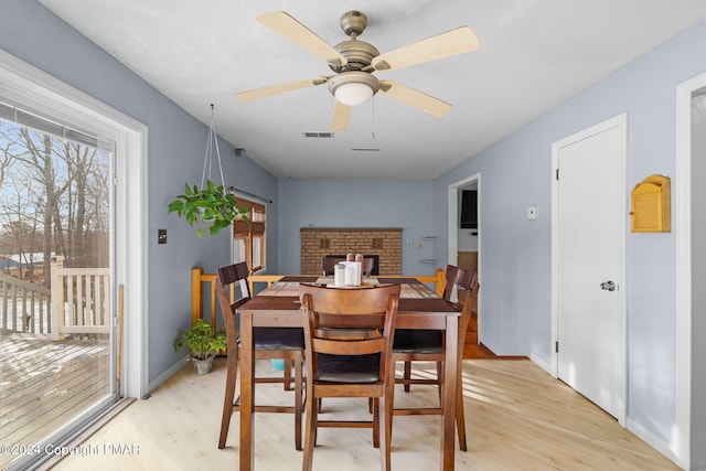 dining space with light wood-type flooring, visible vents, ceiling fan, and baseboards