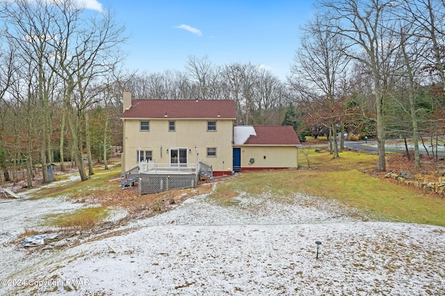 rear view of house with a chimney and a wooden deck