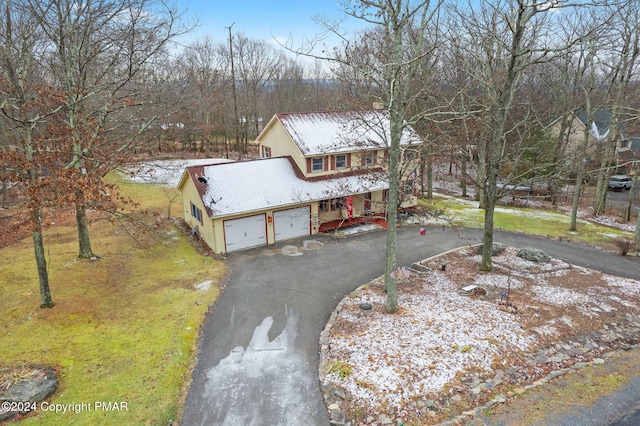 view of front facade with driveway, a front yard, an attached garage, and stucco siding