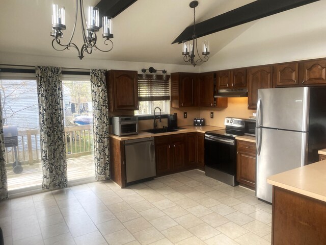 kitchen featuring an inviting chandelier, under cabinet range hood, appliances with stainless steel finishes, light countertops, and a sink