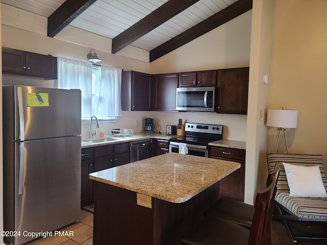 kitchen with dark brown cabinetry, lofted ceiling with beams, light stone countertops, stainless steel appliances, and a sink