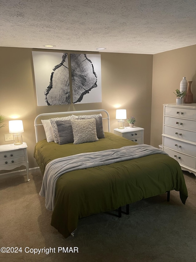 carpeted bedroom with a textured ceiling