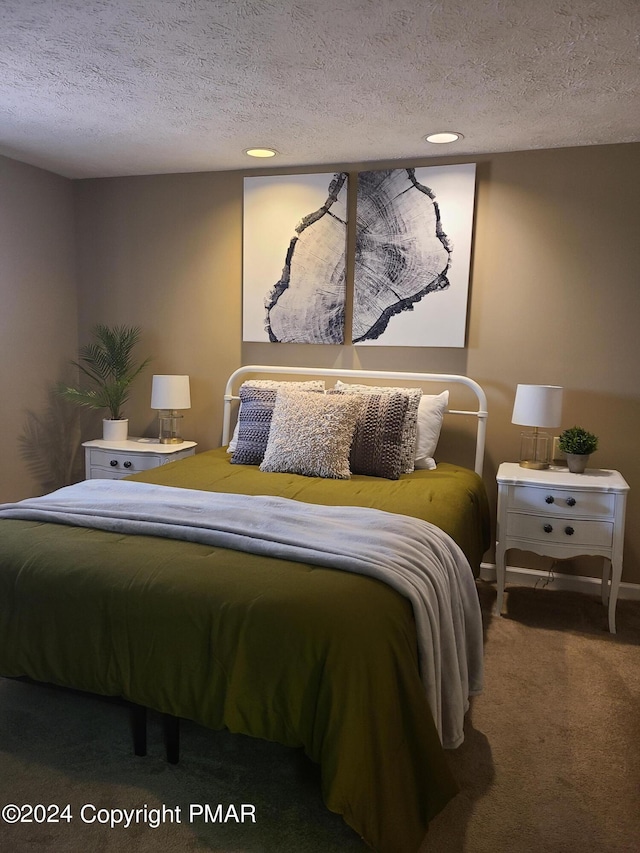 carpeted bedroom with recessed lighting and a textured ceiling