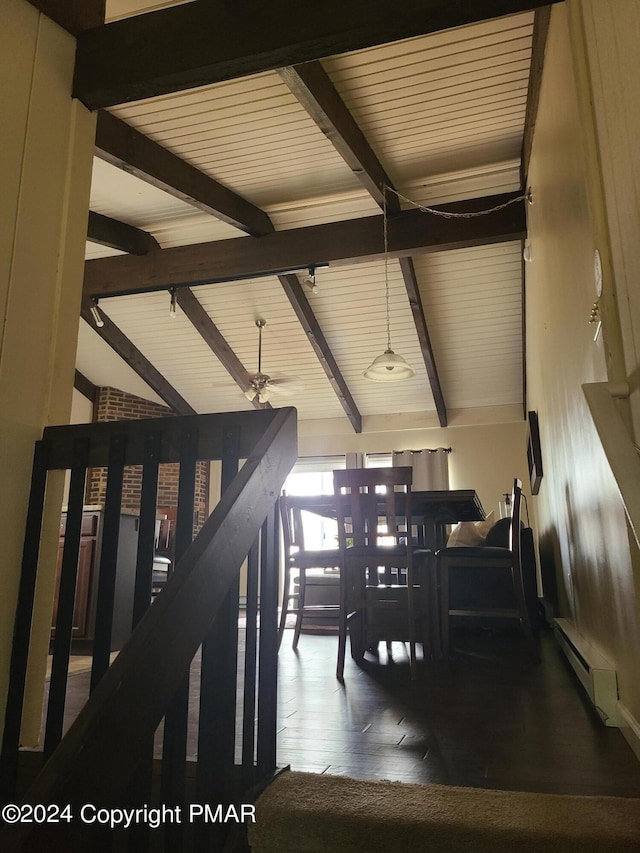 interior space featuring vaulted ceiling with beams, a baseboard heating unit, and wood finished floors