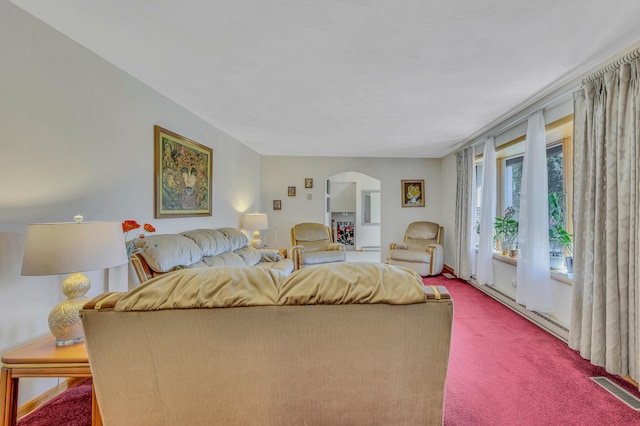 bedroom with arched walkways, visible vents, carpet flooring, and a baseboard heating unit