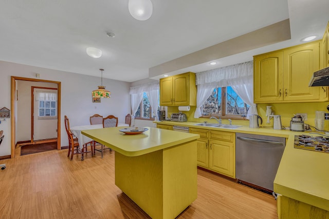 kitchen featuring a sink, light countertops, light wood-style floors, dishwasher, and a center island