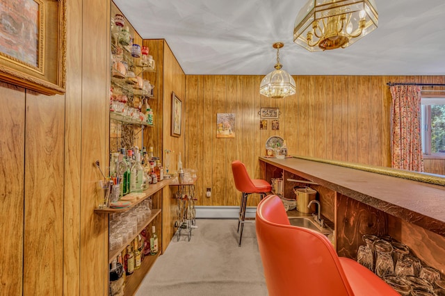 interior space with wooden walls, a dry bar, and baseboard heating