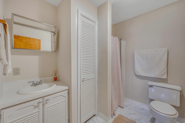 bathroom featuring baseboards, toilet, a closet, marble finish floor, and vanity