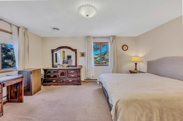 carpeted bedroom with visible vents and a baseboard radiator