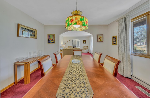 dining room with carpet, visible vents, baseboards, a baseboard radiator, and arched walkways