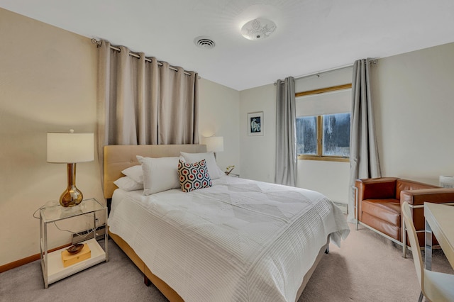 bedroom with visible vents, baseboards, and light colored carpet