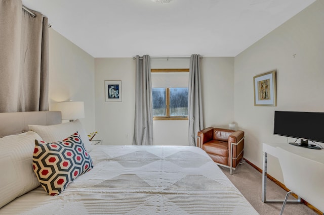 bedroom featuring carpet and baseboards